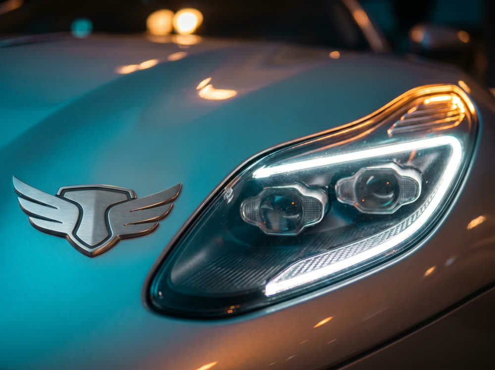 Macro detail shot of a car badge and headlight